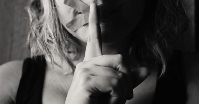 woman placing her finger between her lips