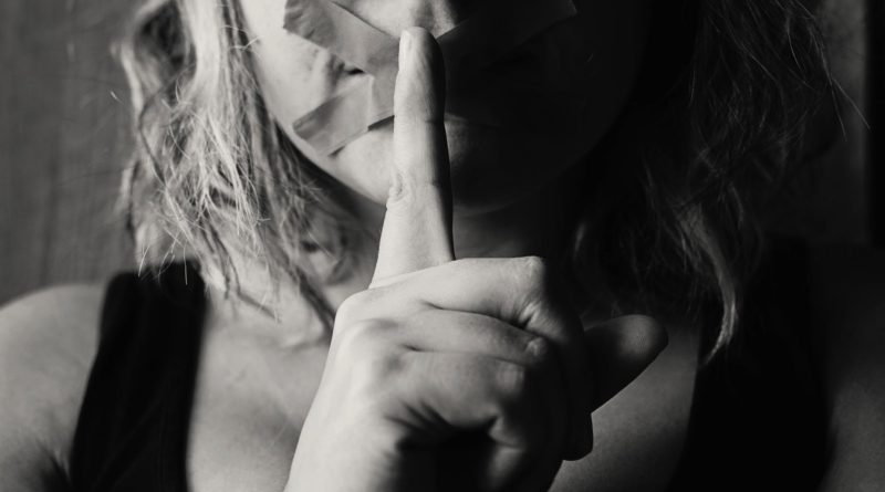 woman placing her finger between her lips